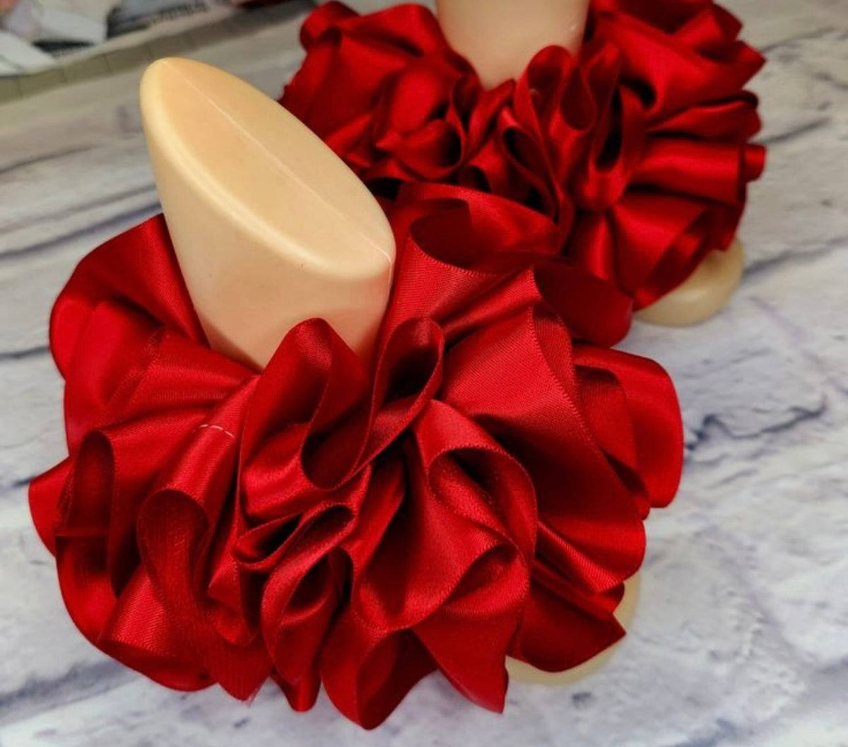 red single color anklets with ruffled satin fabric design on display stands