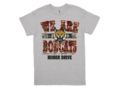 Gray Homer Drive WE ARE BOBCATS spirit shirt with bobcat mascot and red camouflage text