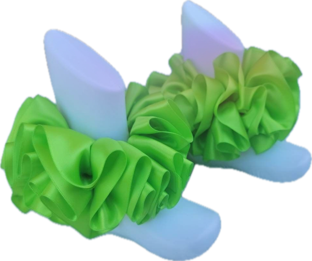 Bright green single color anklets with ruffled fabric design on white display feet