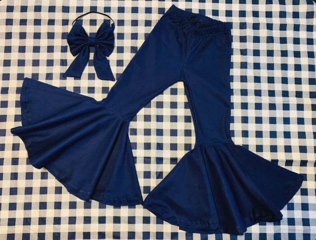 Navy blue school uniform flare pants with a matching bow on checkered background